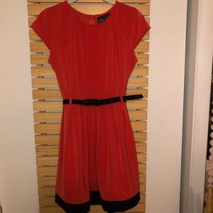 Deep orange dress with black details.